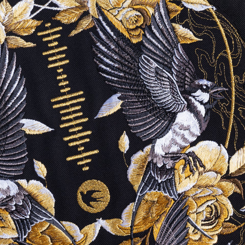 The Custom Song Code Unisex Embroidered Hoodie features black and white birds with outstretched wings among gold roses on a black background, soundwave detail, and bird silhouette—perfect for a unique moonlit garden-inspired look.