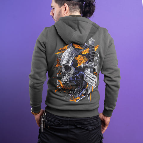 A dark-haired man with a ponytail stands against a purple background, wearing the Skull Unisex Embroidered Hoodie with orange leaves and a dagger design—ideal for gothic streetwear fans.