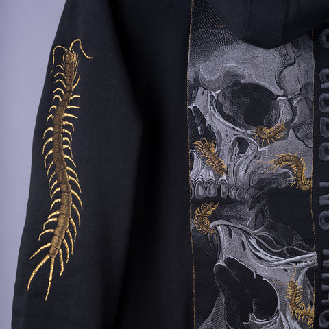The Skull & Scolopendras Limited Edition Embroidered Hoodie showcases a bold gold centipede on the sleeve and a graphic skull with centipedes on the back—ideal for dark art streetwear fans.