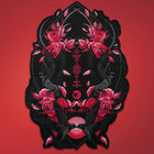 The Spotify Song Code Embroidered Patch features ornate embroidery with red and pink roses, mirrored black birds, and geometric designs on a red background, creating a striking, customizable accessory.