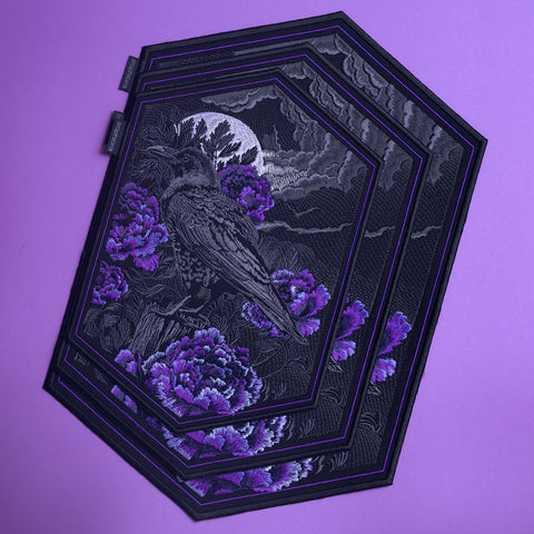 The Crow & Peonies Goth Embroidered Patch features a raven among purple peonies under a full moon, set on a lavender background with black and purple borders—ideal for Victorian fashion and gothic style lovers.